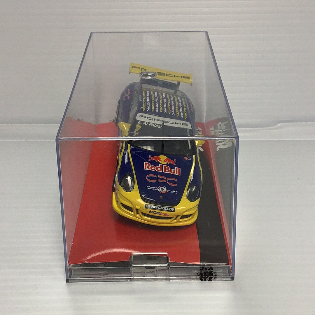 Slot car of a red and yellow Porsche 911 GT3 Cup race car for SCX A10119X3U0