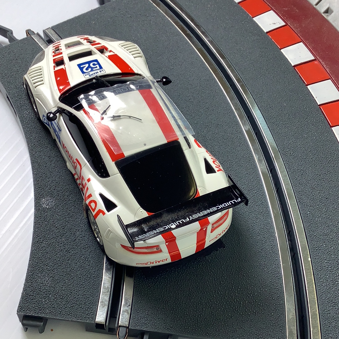 White and red race car model on a train track for SCX A10304X3U0