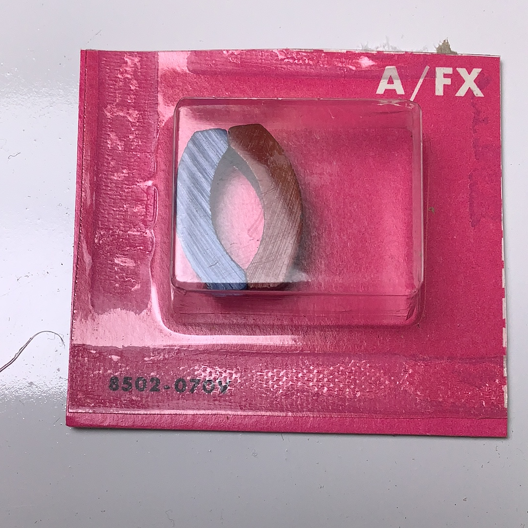 Two curved magnets in a pink card packaging, labeled A/FX for Aurora / AFX / Tomy 502