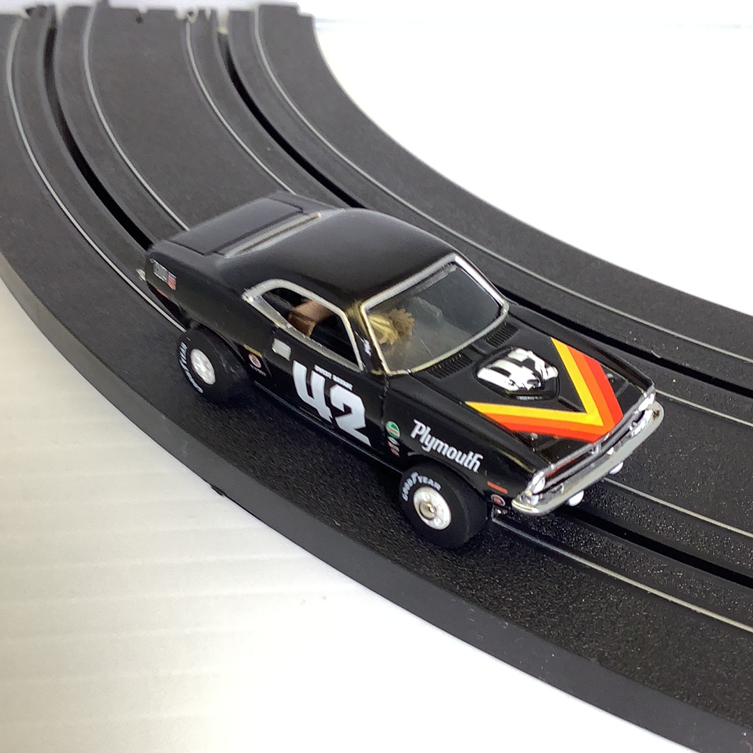 Black Plymouth race car on curved black model train track for Auto World Track SRS001D