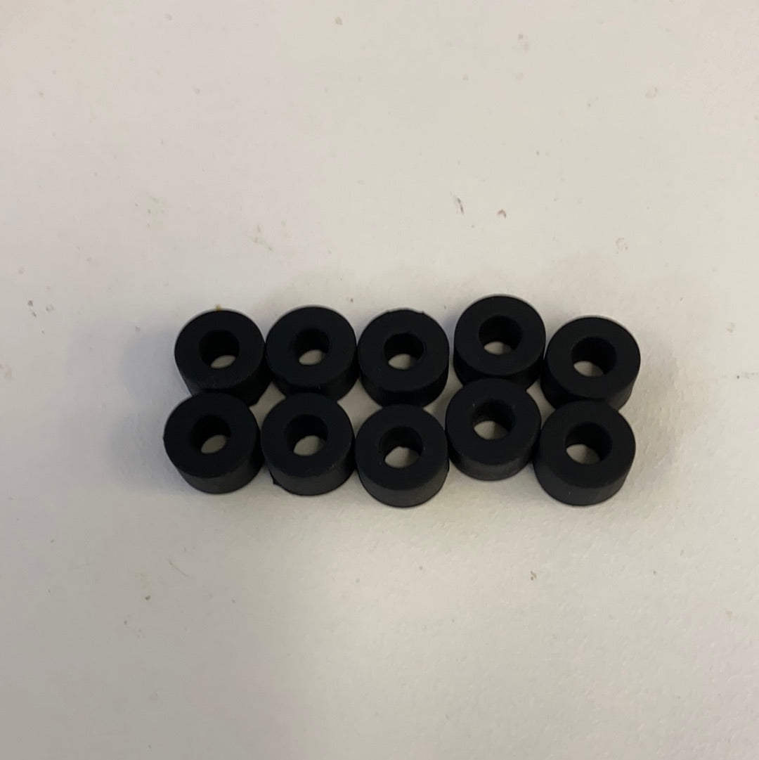 Ten black slot car rear tires arranged in two rows for Auto World CP7911