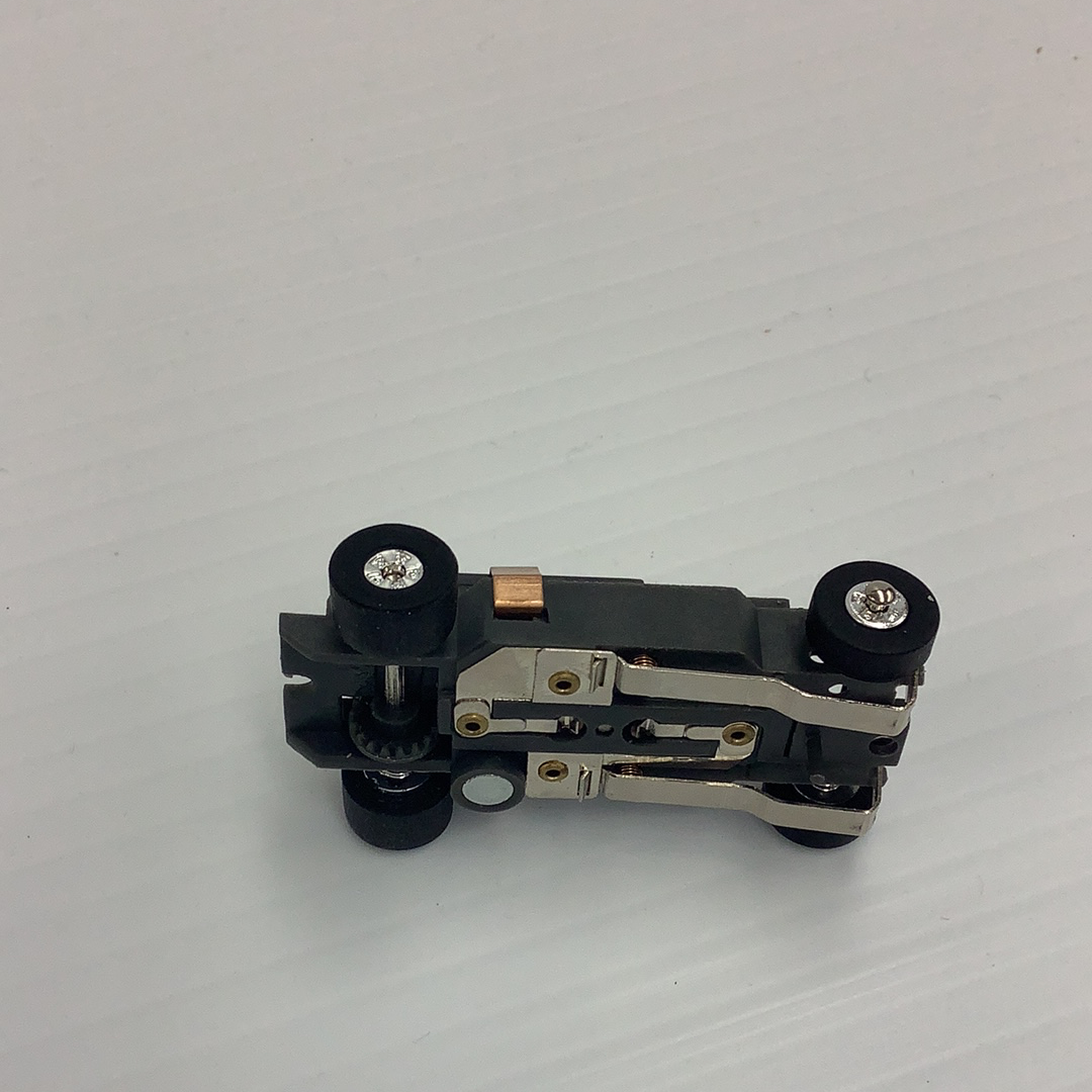 Slot car chassis with black wheels and silver metal components for Auto World PSCTJ-029, rear view