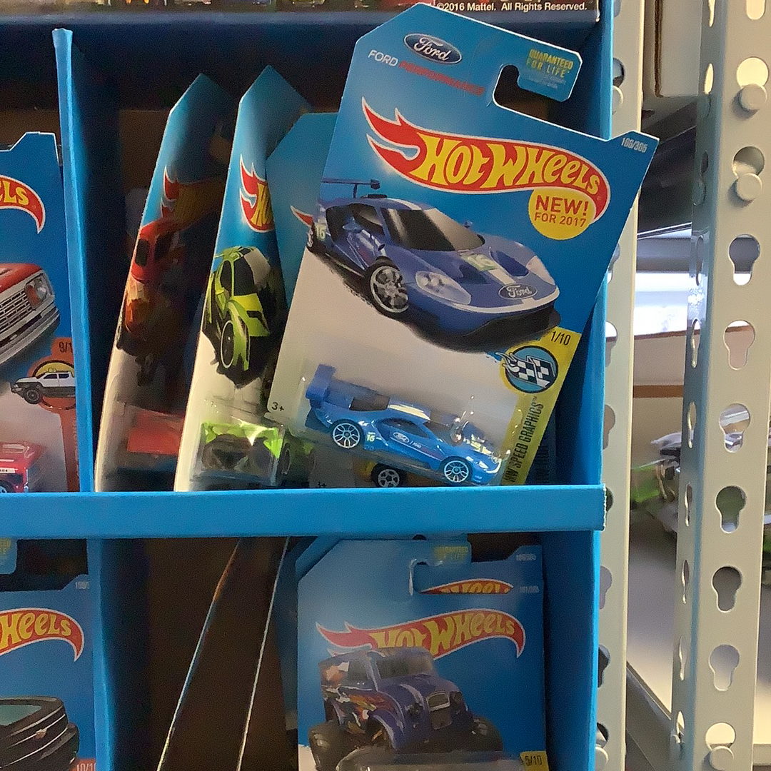 Assorted die-cast toy cars displayed on blue shelving for UPD FDY58-K910 l Assorted, rear view