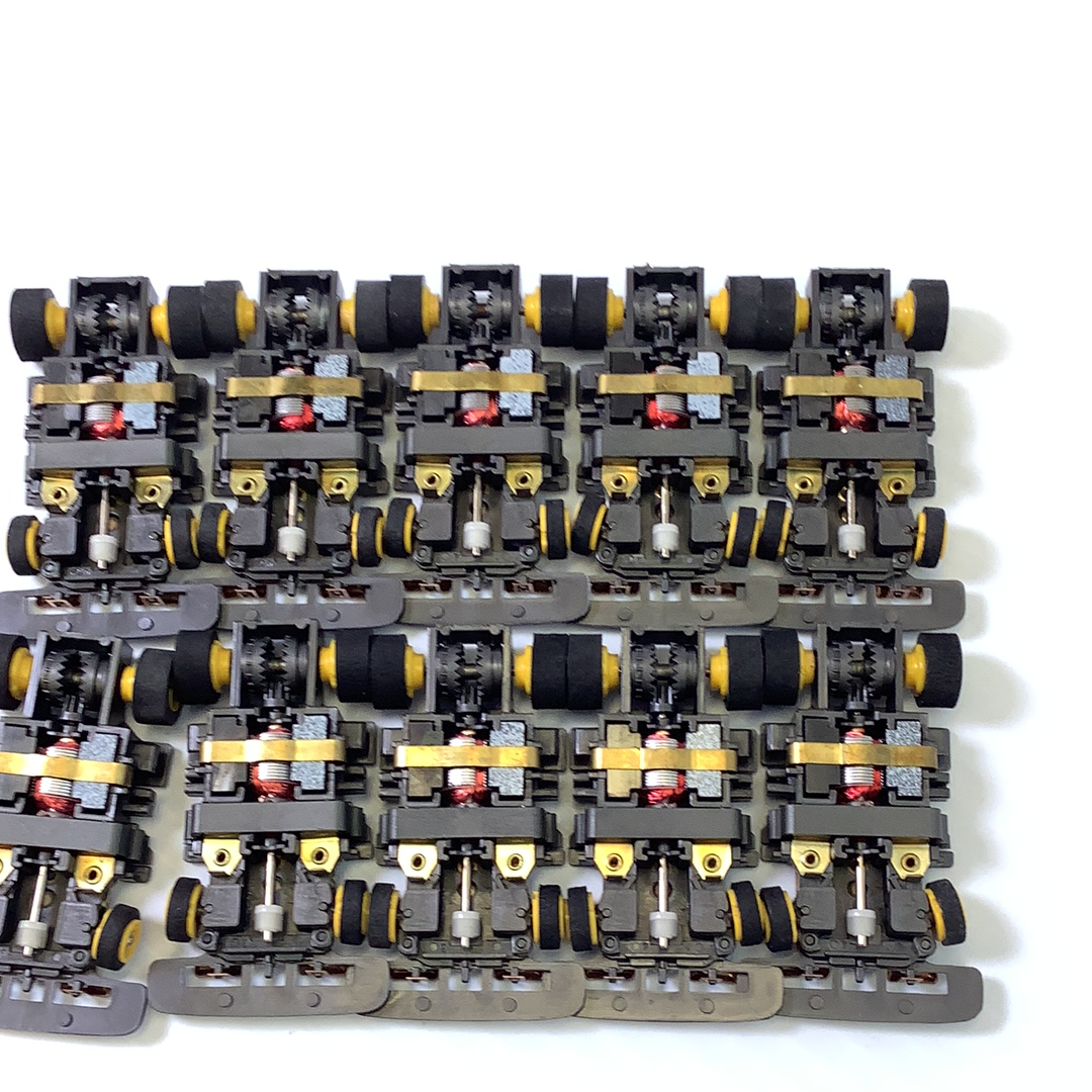 Assortment of black and yellow train chassis for model building for Tyco TCR TCR1501