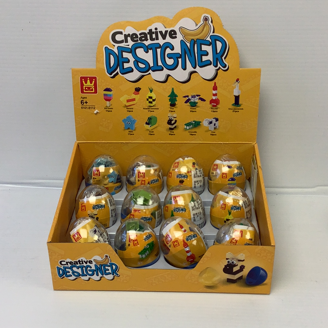 Assortment of decorated, egg-shaped craft items in a yellow box for IMEX Model Company WAG61016