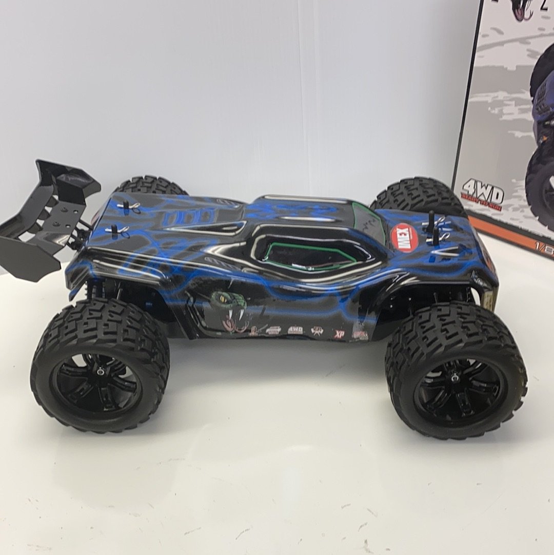 Black and blue remote-controlled truggy with large off-road tires for IMEX 22000, front view