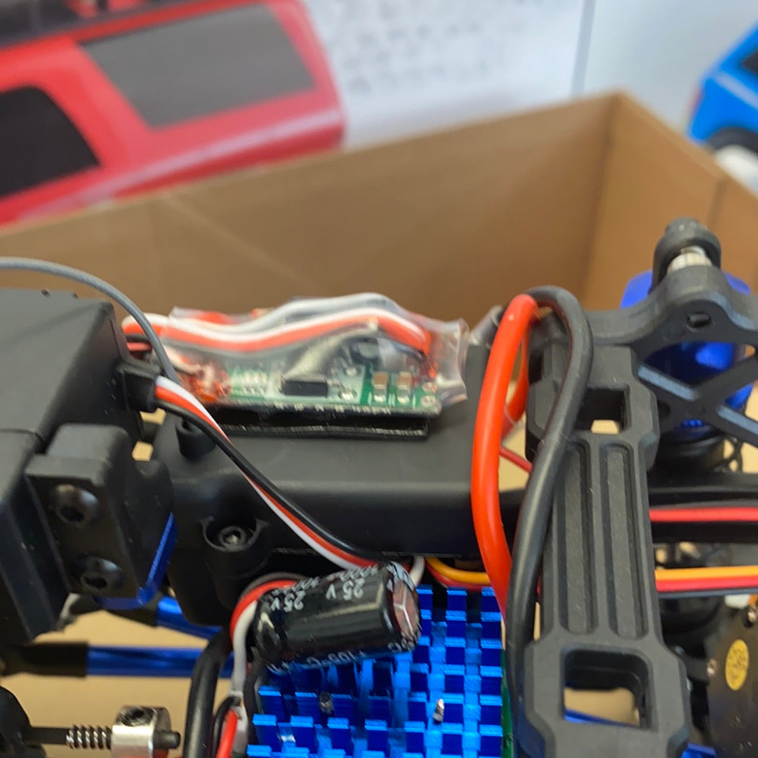 Electronics components and wiring on a remote-controlled truck chassis for IMEX 22020