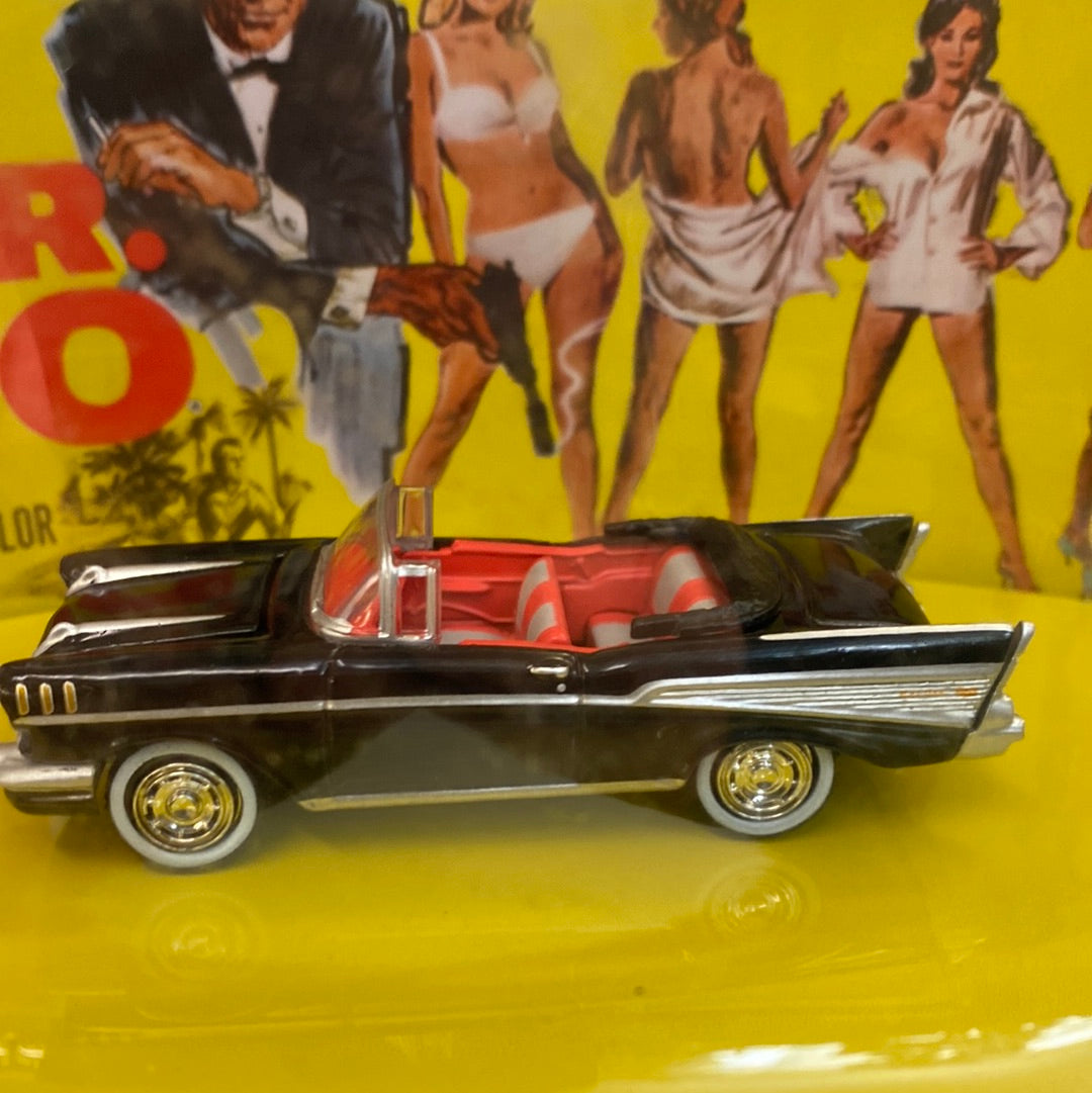 Black 1957 Bel Air convertible toy car on yellow background for Johnny Lightning JLDR013