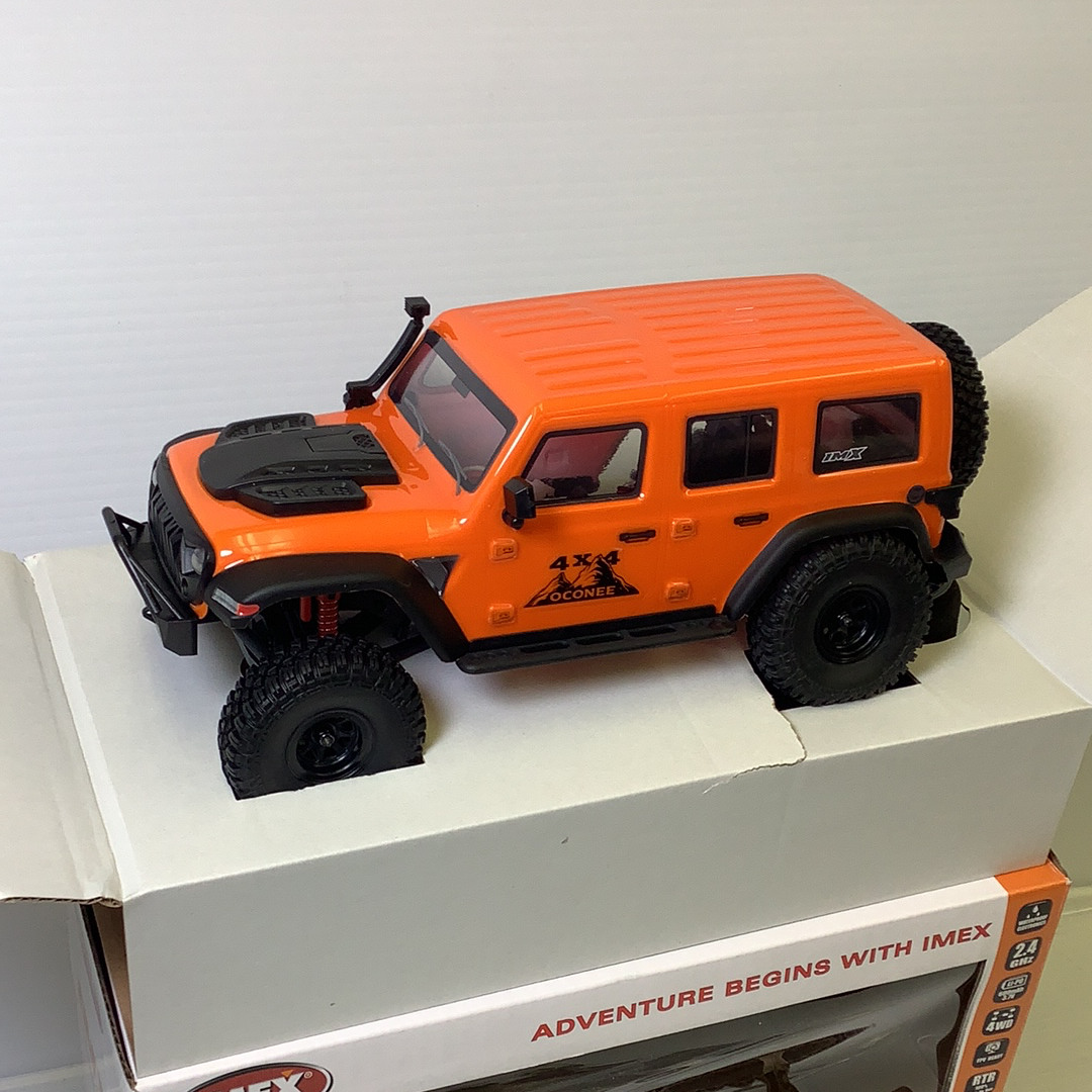 Orange 4x4 scale crawler vehicle on a white box for IMX IMX25015