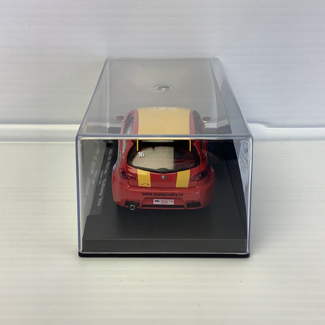 Red and yellow slot car in a clear display case for Fly Car 88197