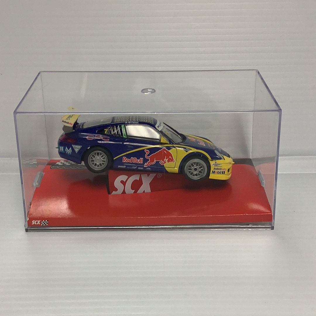 Slot car of a Porsche 911 GT3 Cup race car in a display case for SCX A10119X3U0