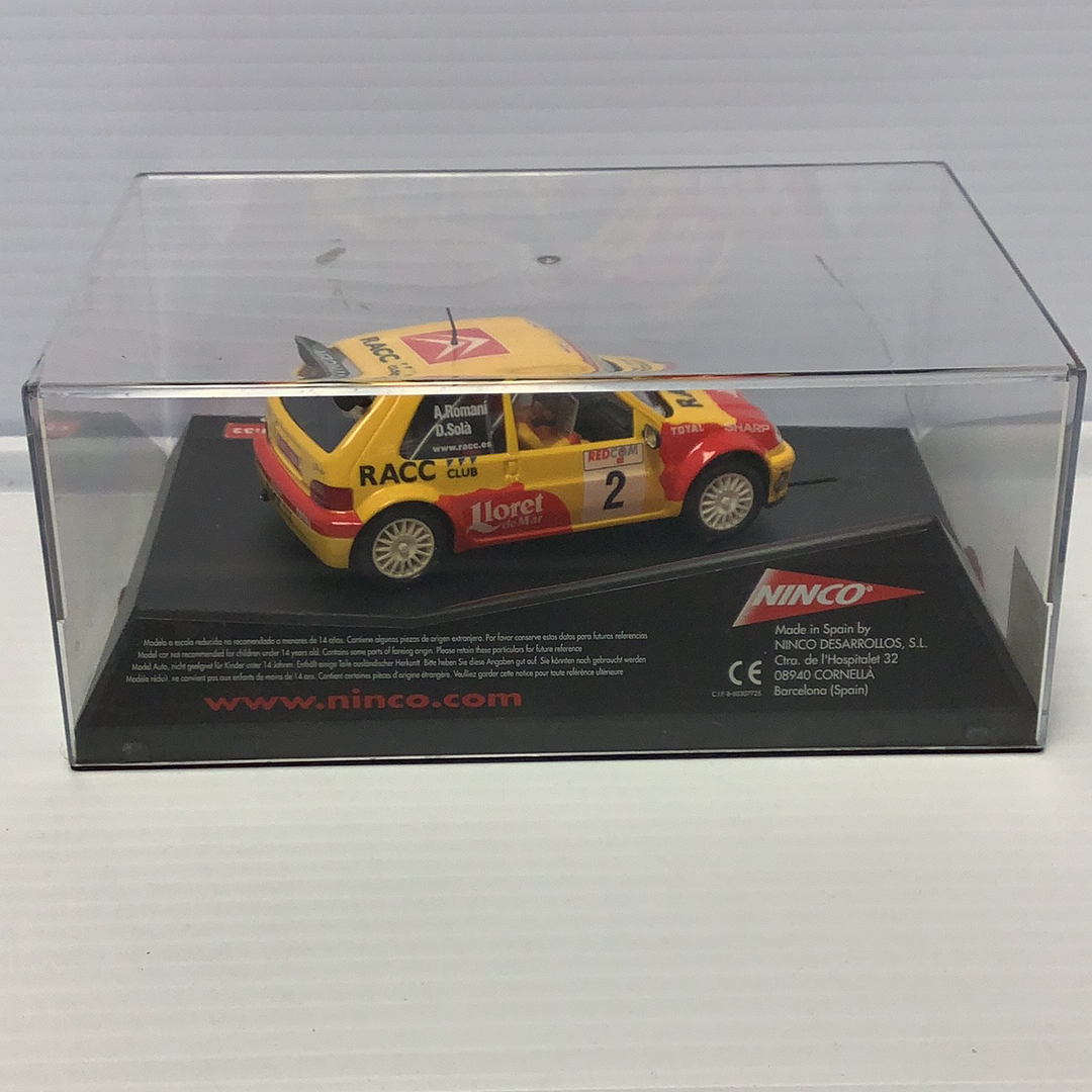 Yellow and red race car model in clear display case for Ninco 50290