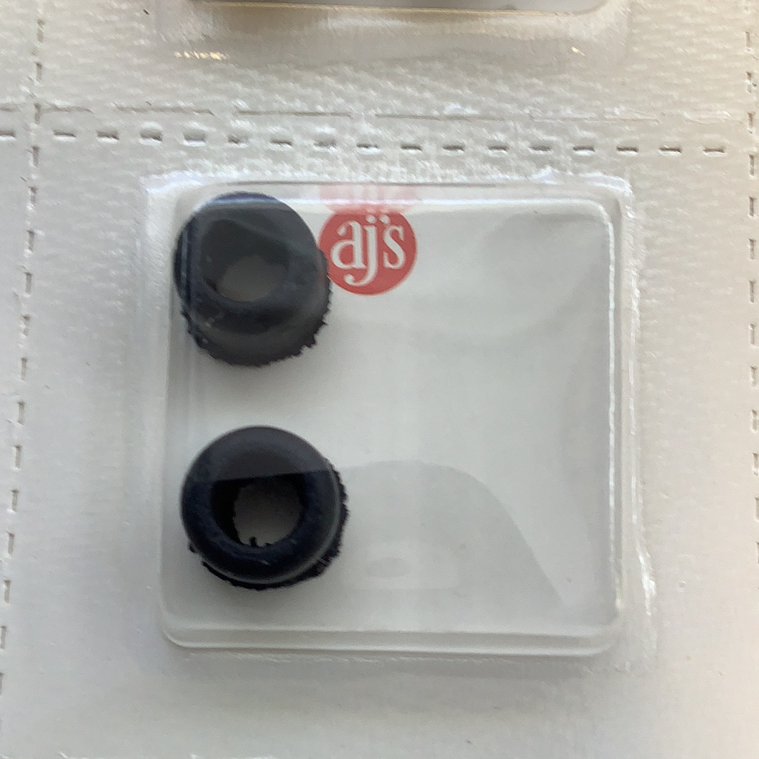 Two black silicone tire bushings in a clear plastic case for HO Tires Silicone Black 785
