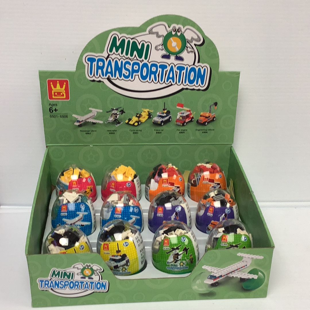 Assortment of mini vehicle toys in a green cardboard box for IMEX Model Company WAG65016