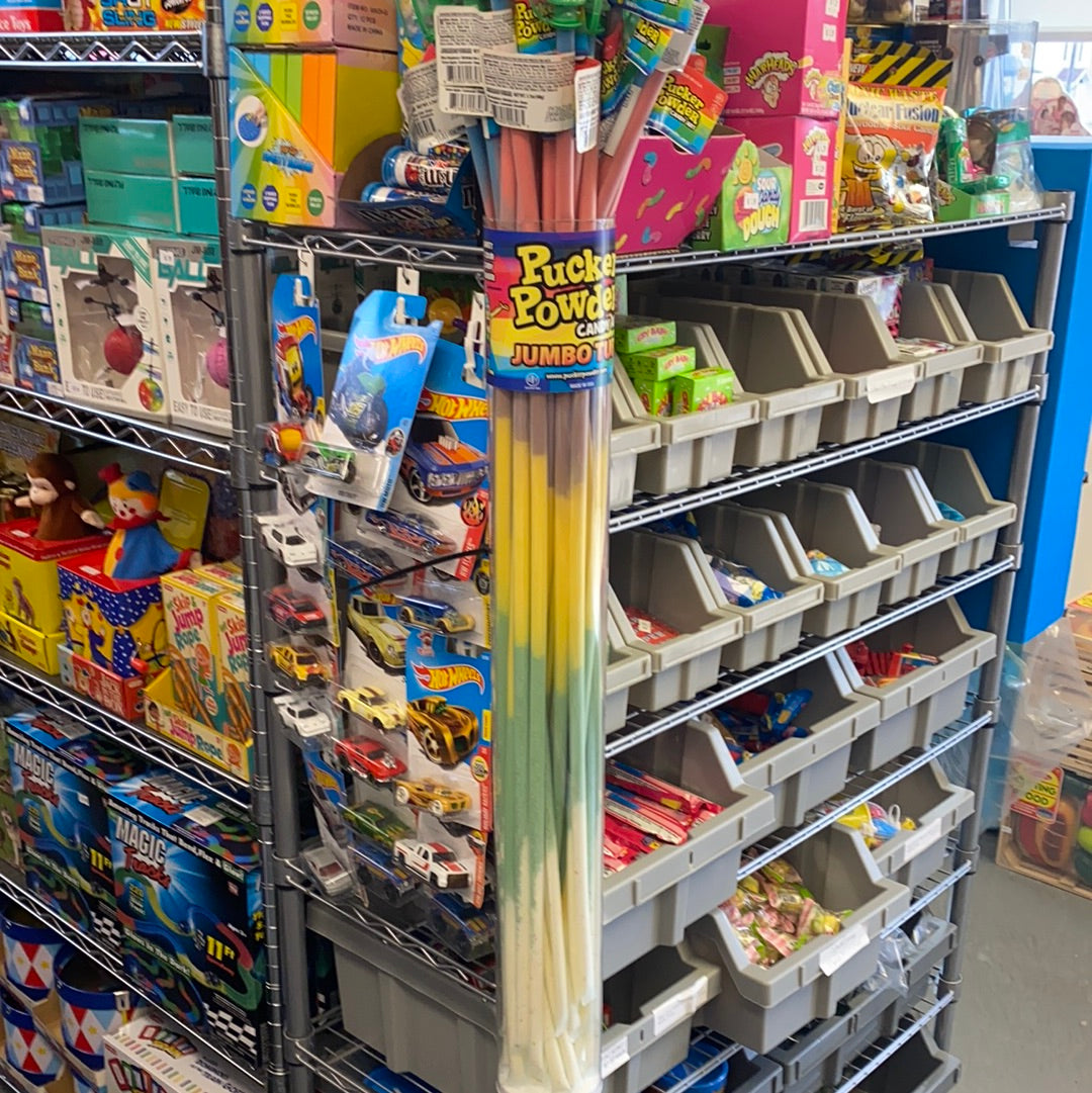 Assortment of colorful candy art sticks displayed on metal shelving for Creative Concepts CPPFTASM