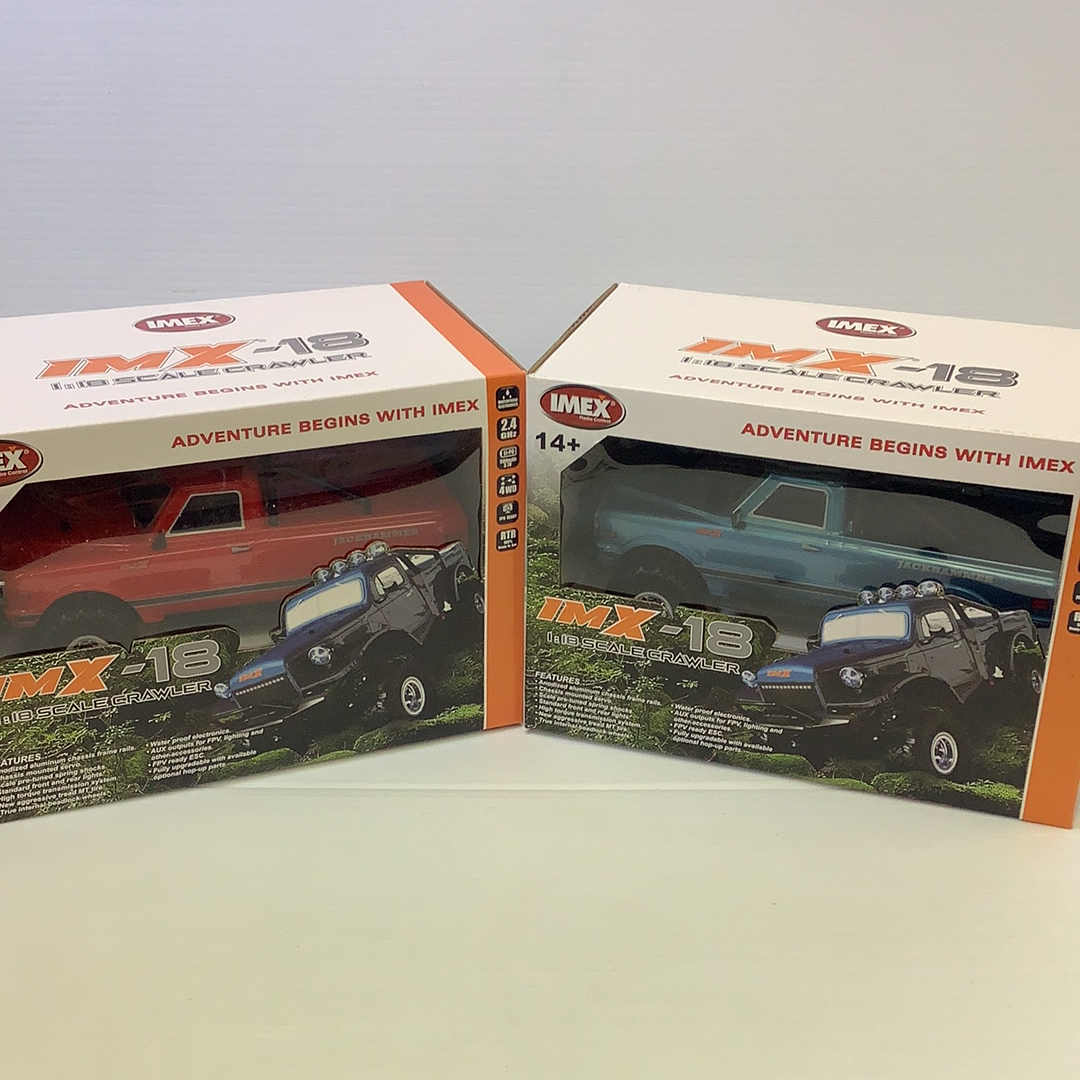 Two toy vehicle boxes showing scale crawler models for IMX IMX25000