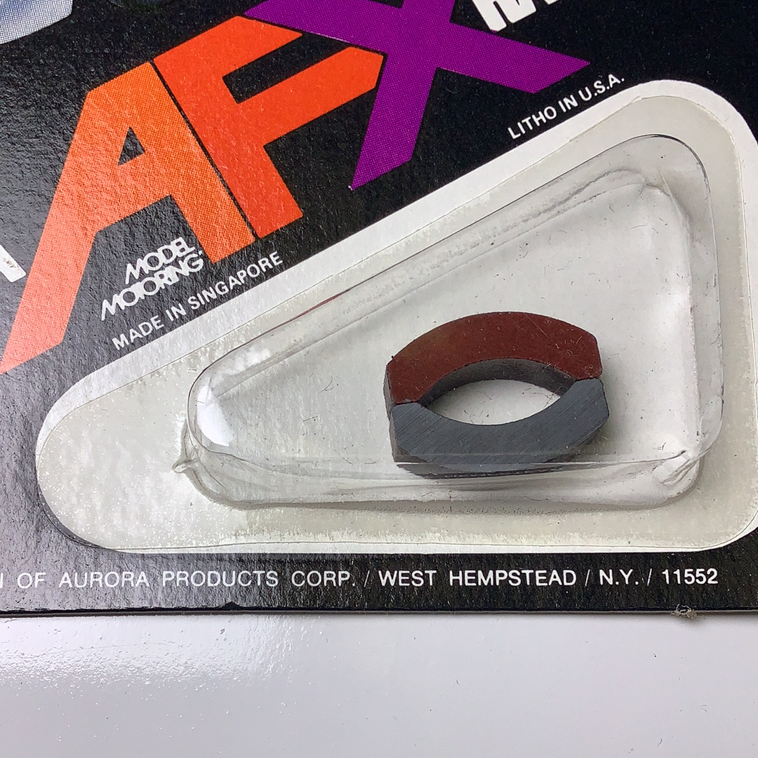 Red and black model magnets packaged in a clear plastic blister card for Aurora / AFX / Tomy 8866