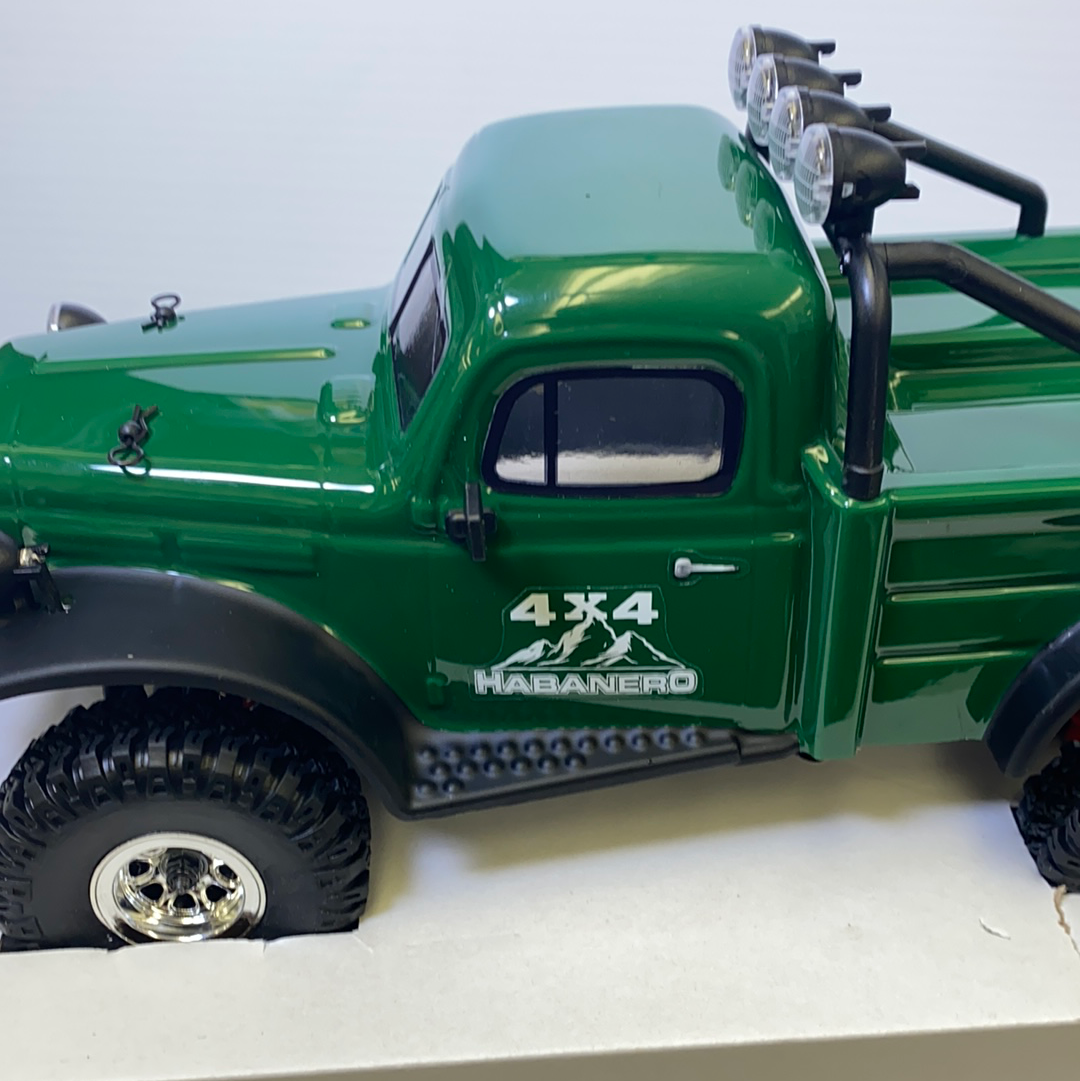Green scale model crawler truck with off-road tires and roof lights for IMX IMX25010
