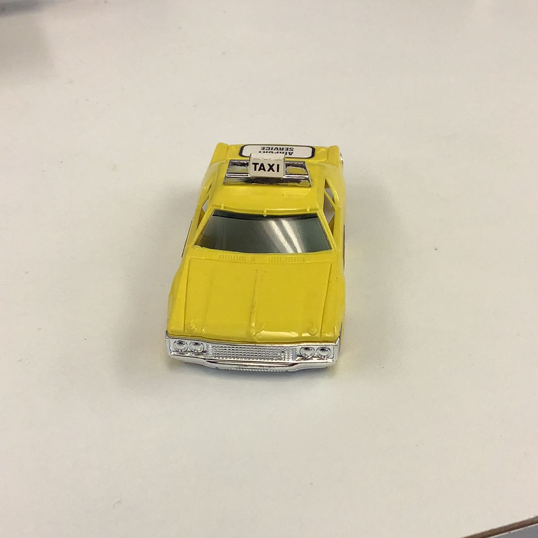 Yellow toy taxi cab with "TAXI" sign on top for Aurora / AFX / Tomy B1939Y