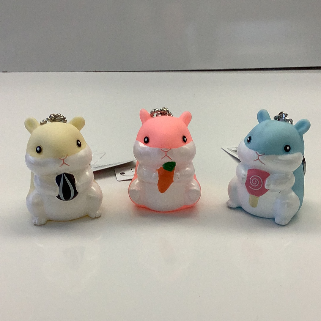 Three cute, stylized hamster charms: yellow, pink, and blue for BC USA 12017, rear view