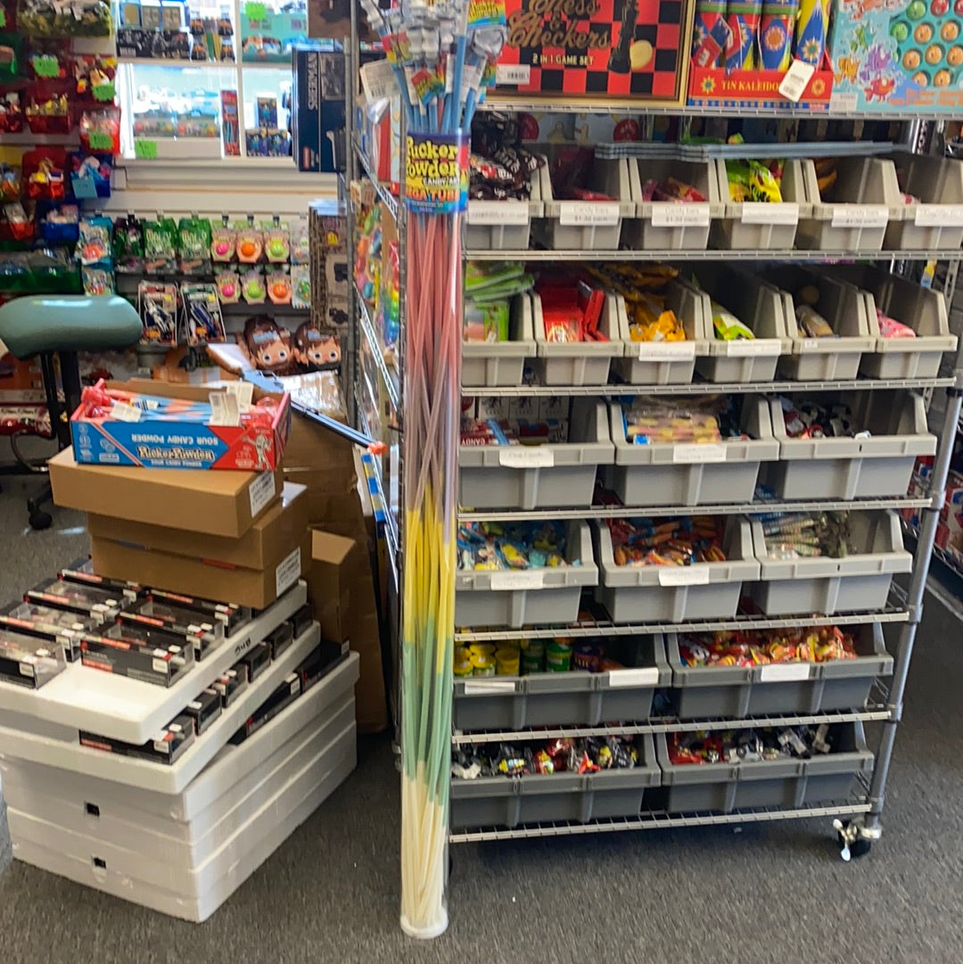 Assortment of colorful candy sticks displayed next to candy shelving for Creative Concepts CPPFTASM