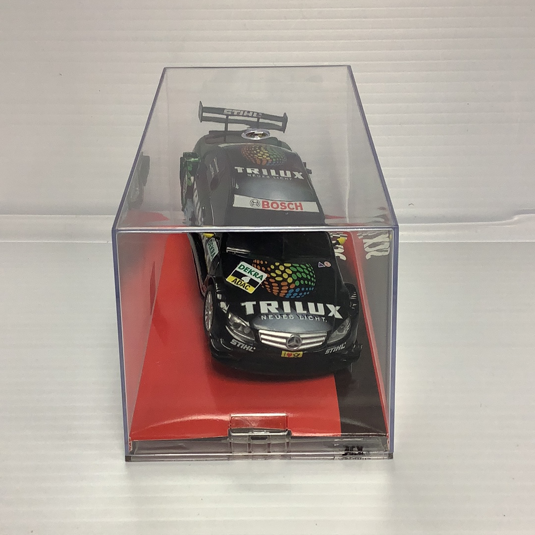 Black and silver race car model in clear plastic display case for SCX A10142X3U0