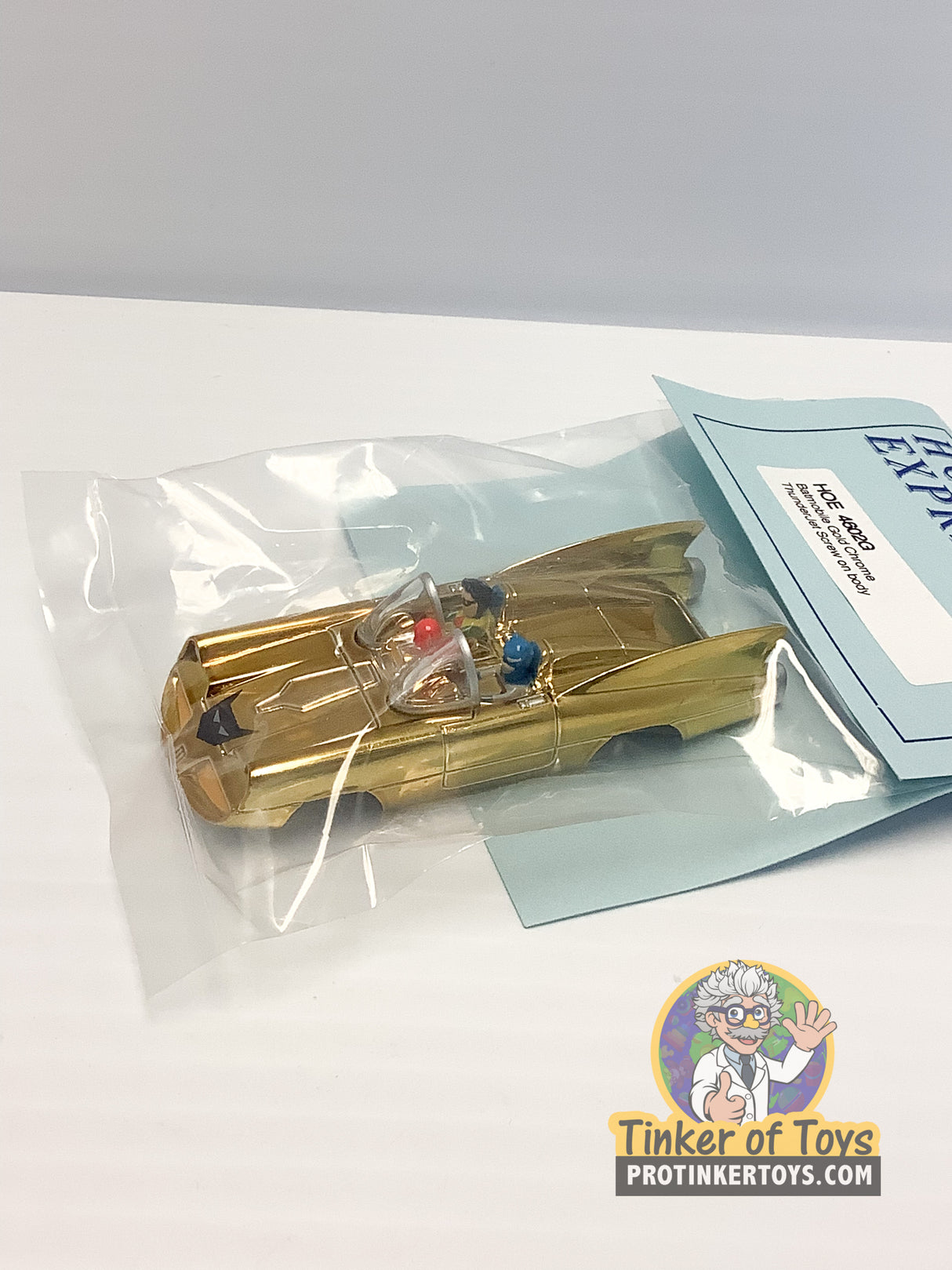 Gold chrome Batmobile die-cast car in clear plastic packaging for HO Express 4602G