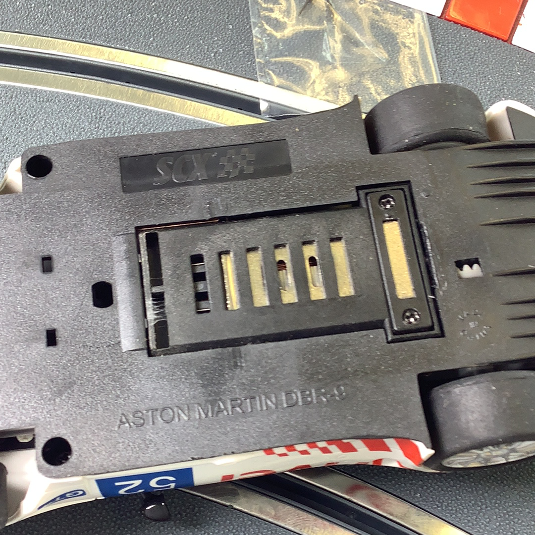 Rear view of a model car's chassis showing model details and markings for SCX A10304X3U0