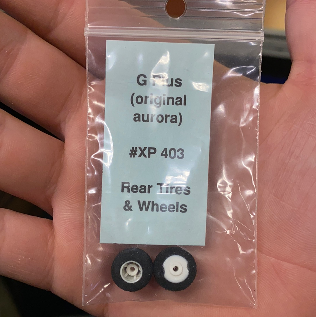 Tires and wheels for model vehicle, labeled XP 403, in clear packaging for G Plus
