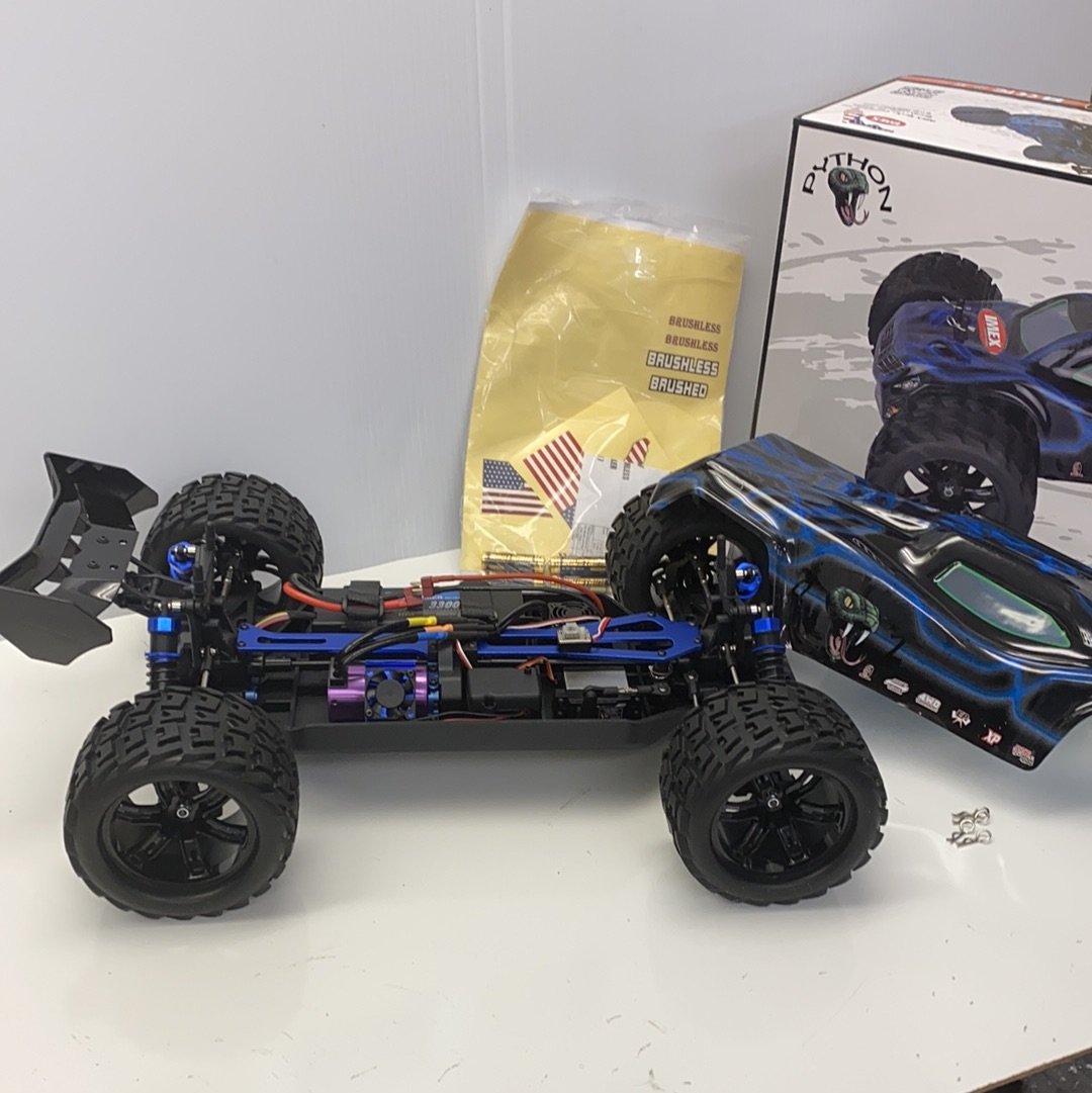 Remote-controlled truggy with large tires and blue/black body for IMEX 22000