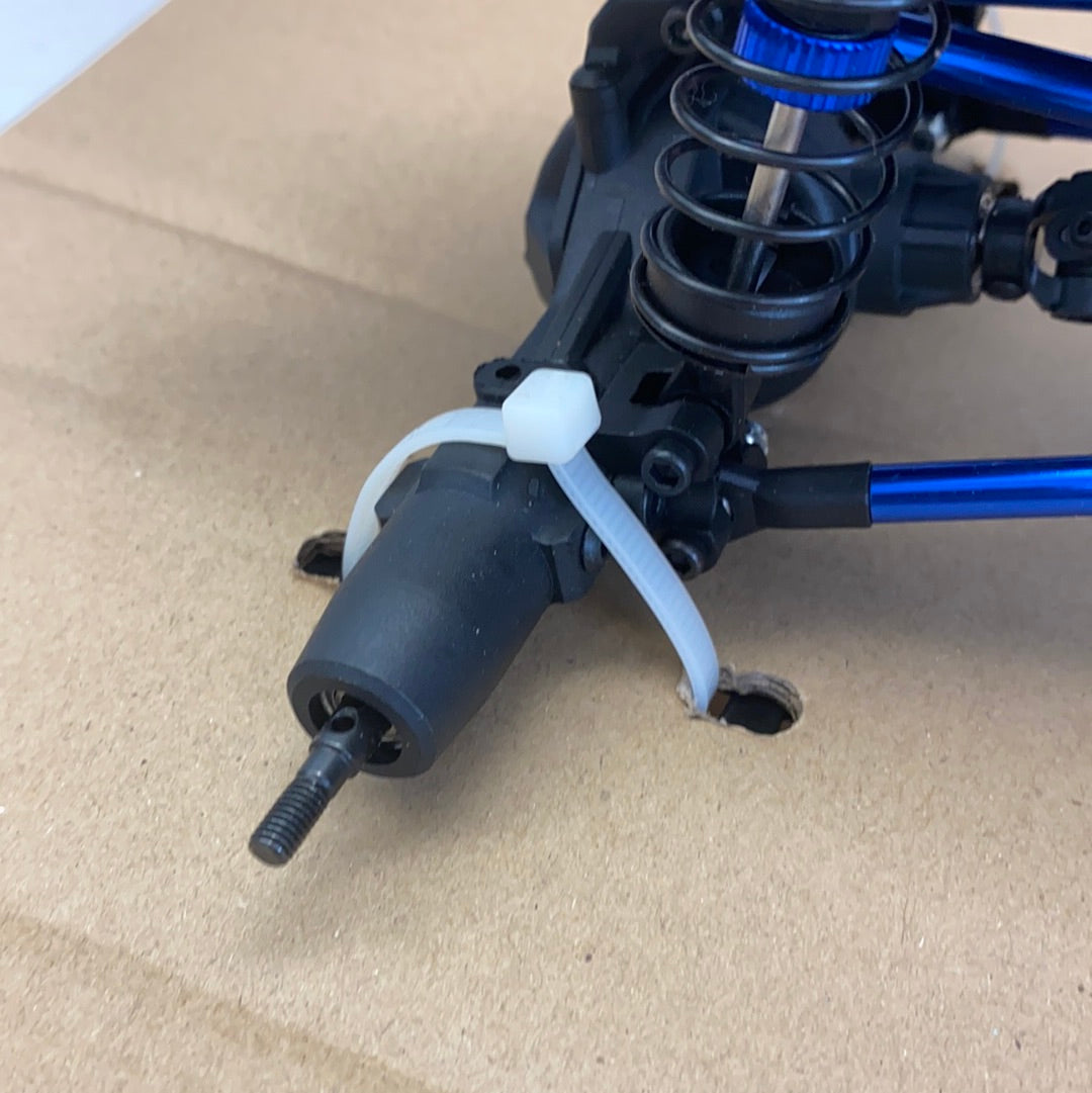 Shock absorber assembly with white coil and black body on brown surface for IMEX 22020