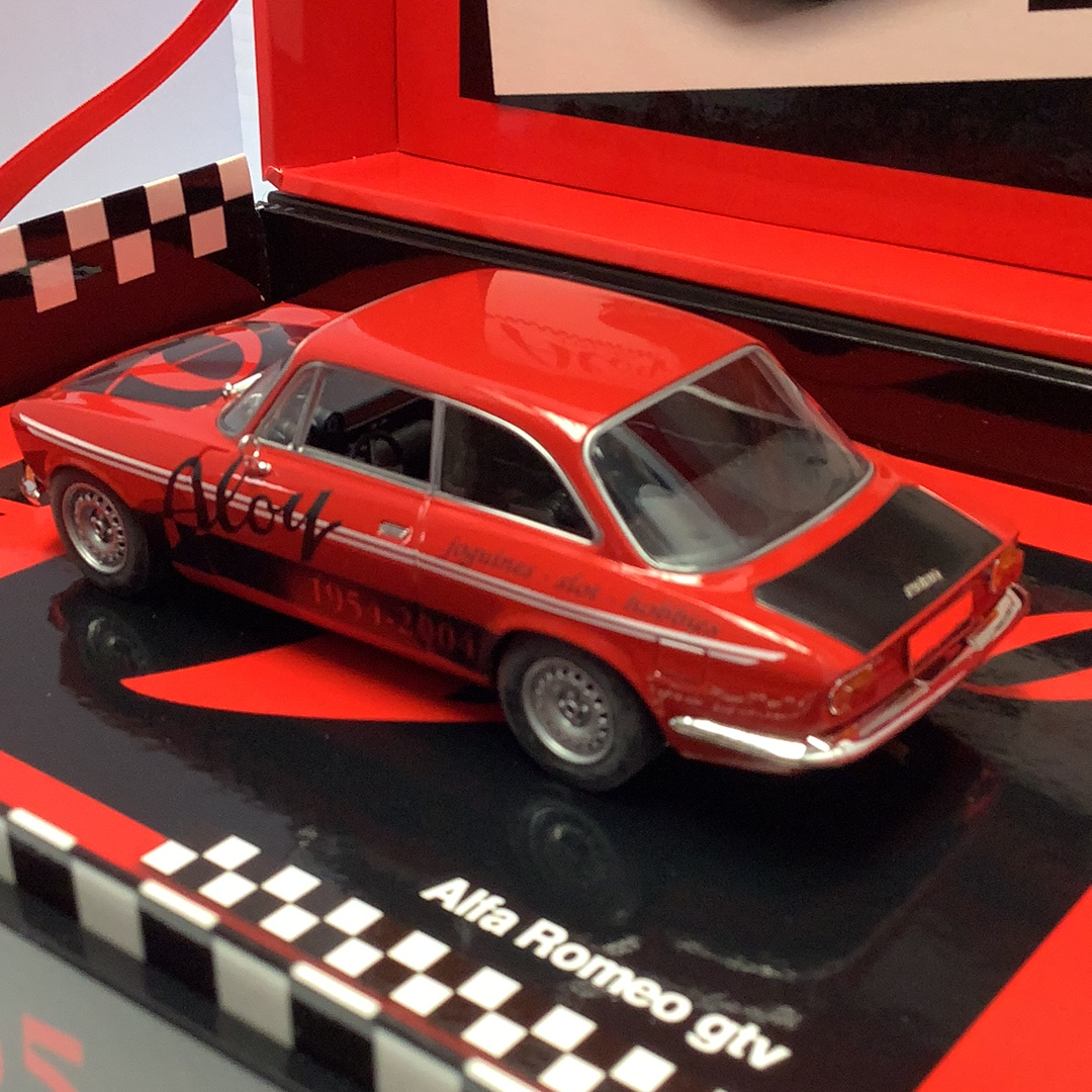 Red slot car Alfa Romeo GTV model car on a display base for Fly Slot Car 96061