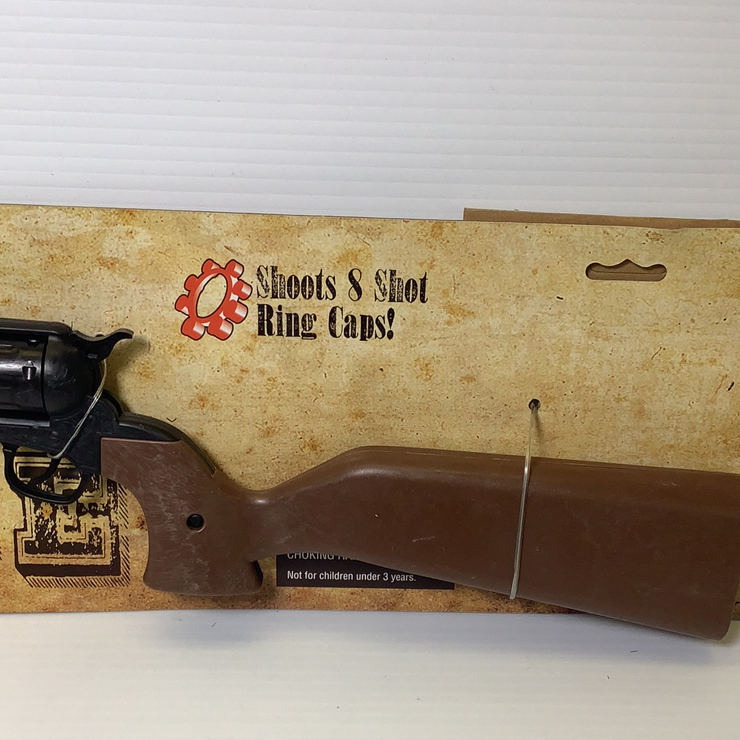 Toy rifle with brown stock and box showing "Shoots 8 Shot Ring Caps!" for Parris Toys 4731C