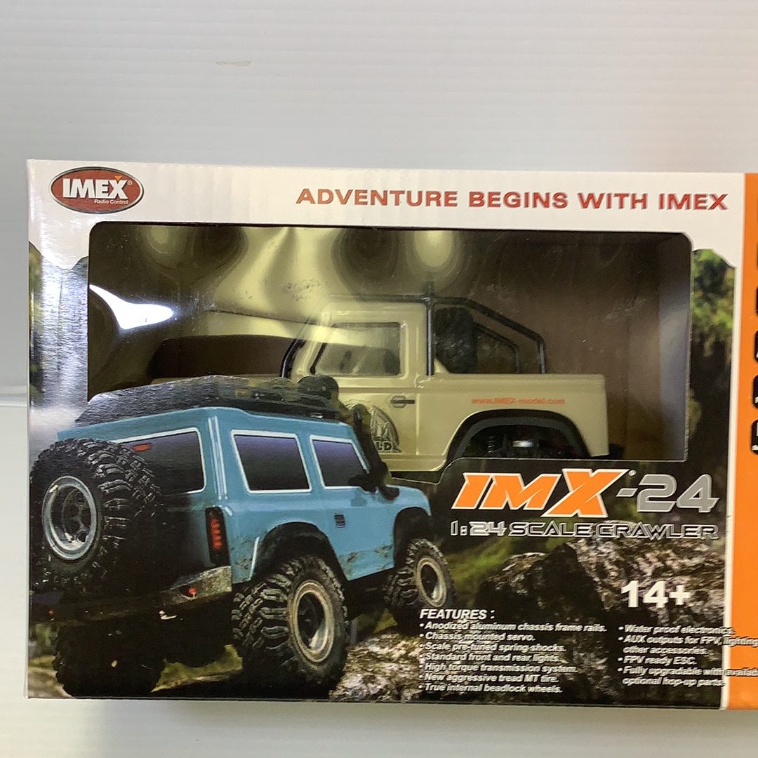 Blue and tan scale crawler toy with off-road tires and detailed build for IMX IMX25050