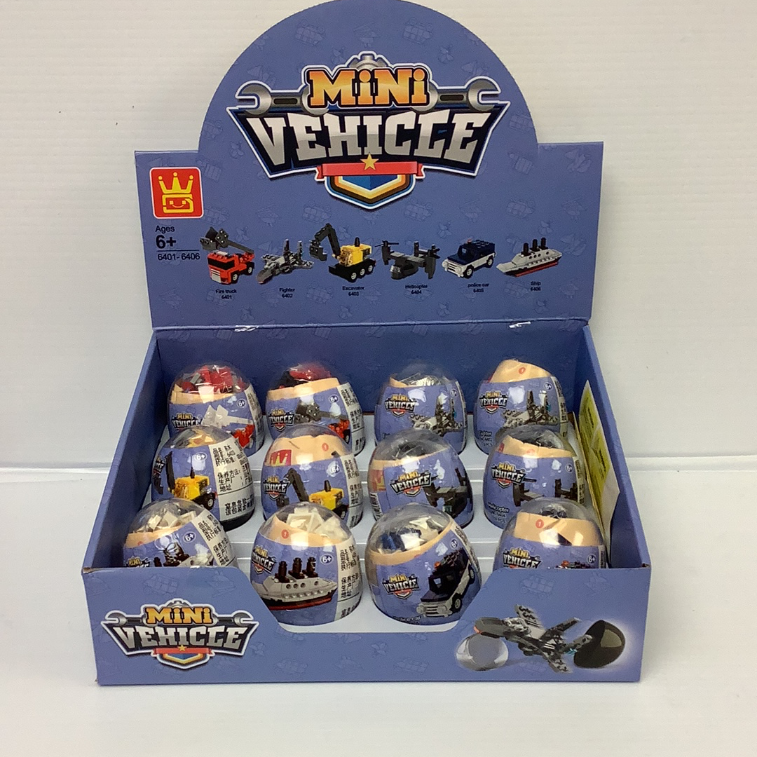 Assortment of mini vehicle themed eggs in a blue cardboard box for IMEX Model Company WAG64016