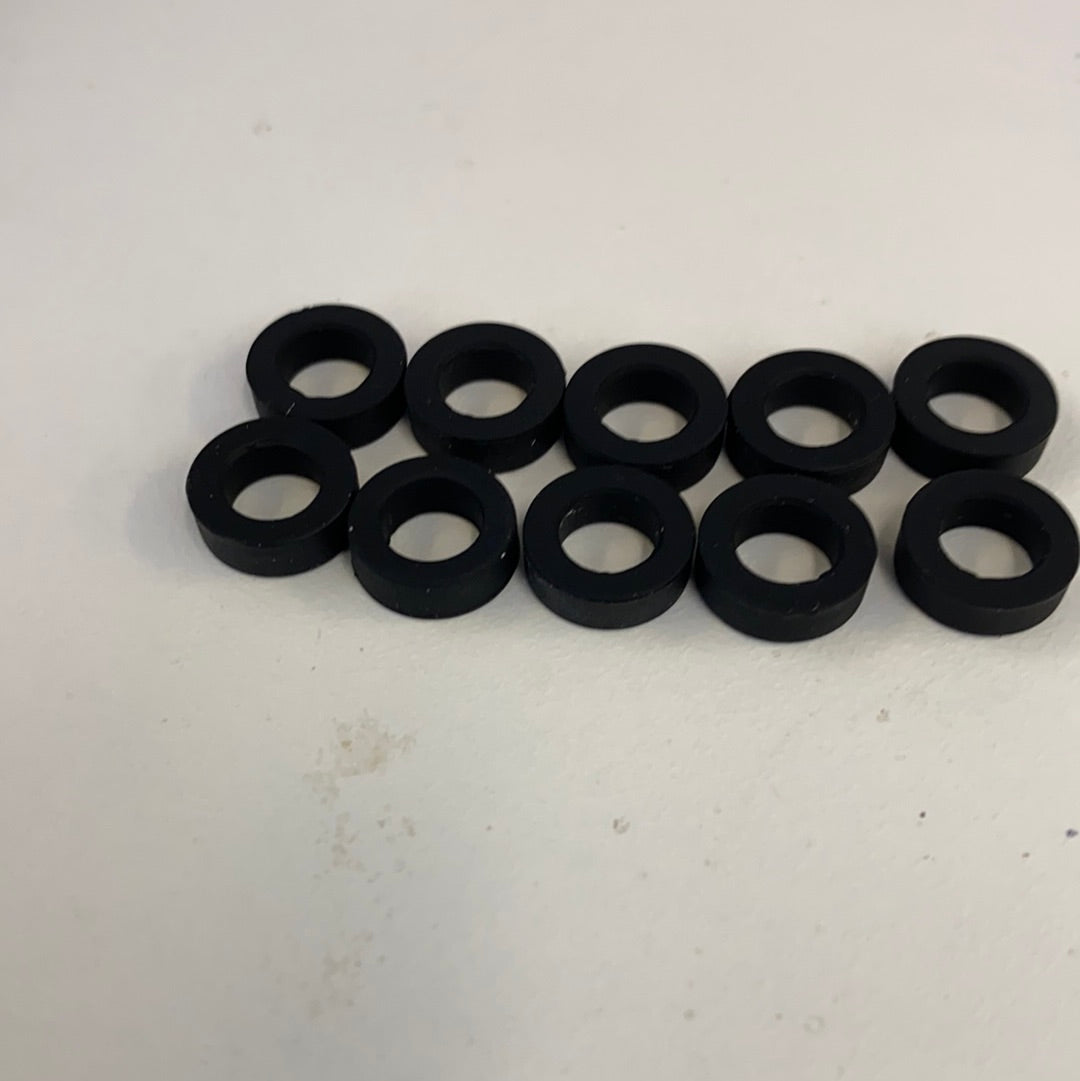 Ten black slot car front tires arranged in two rows for Auto World CP7906