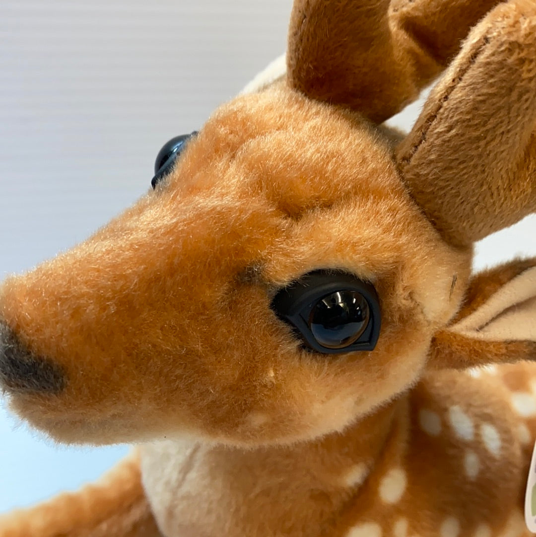 Close-up of a stuffed deer toy's head, showing its brown fur and black eyes for Real Planet DE32P