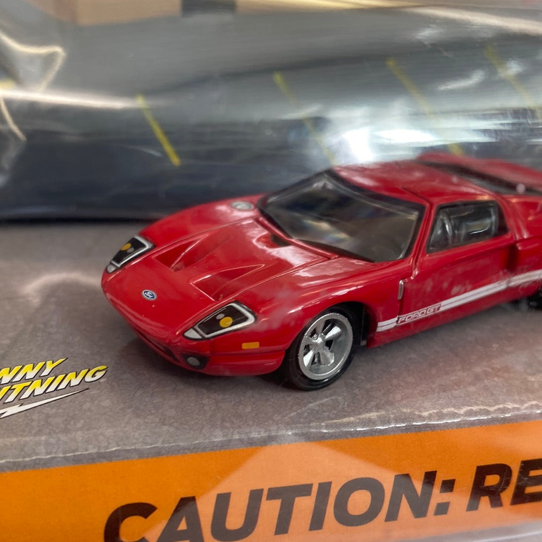 Red Ford GT die-cast car on a display box for Johnny Lightning JLDR004R