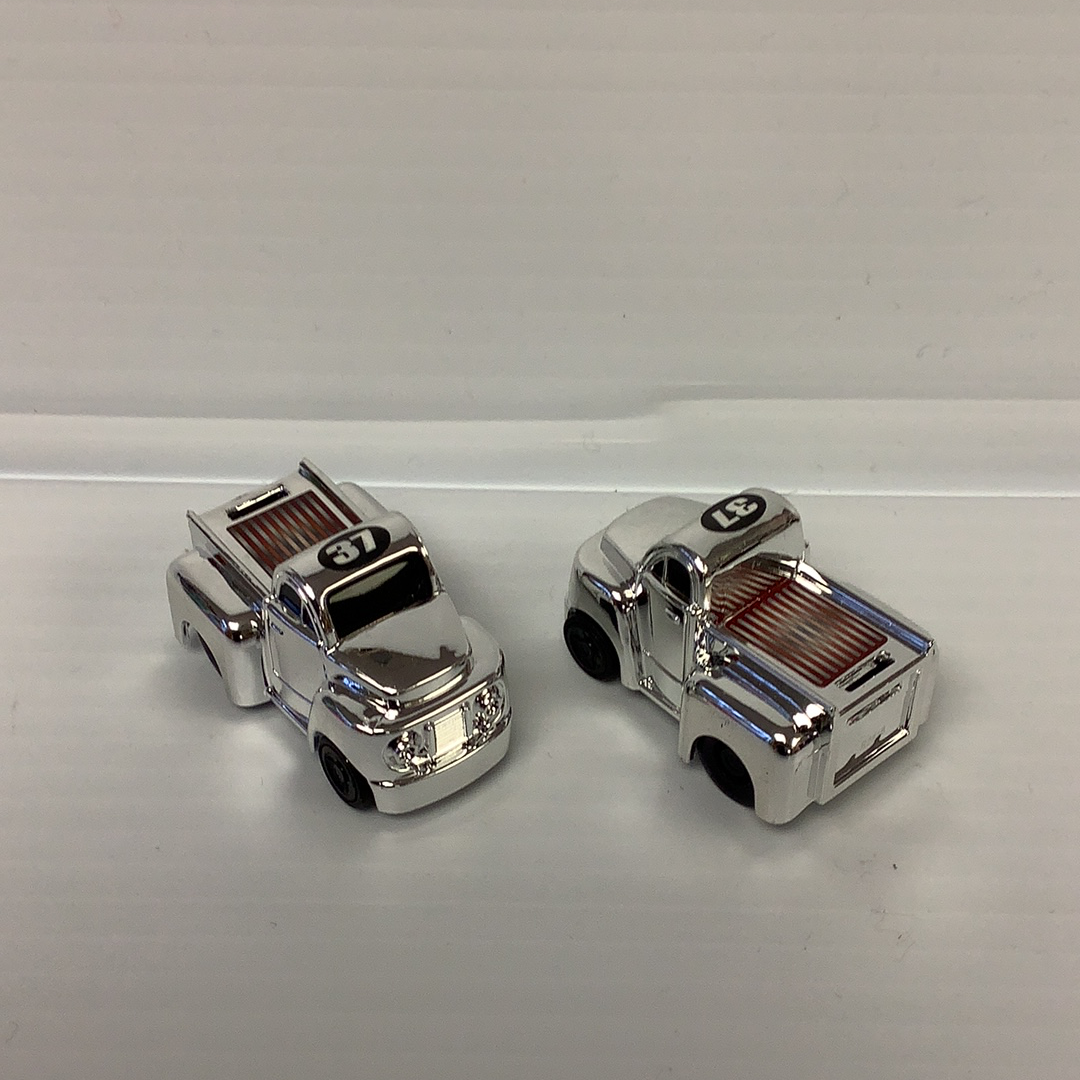 Two silver, miniature police cruiser toys with "37" marked on the front for California Creations 20552