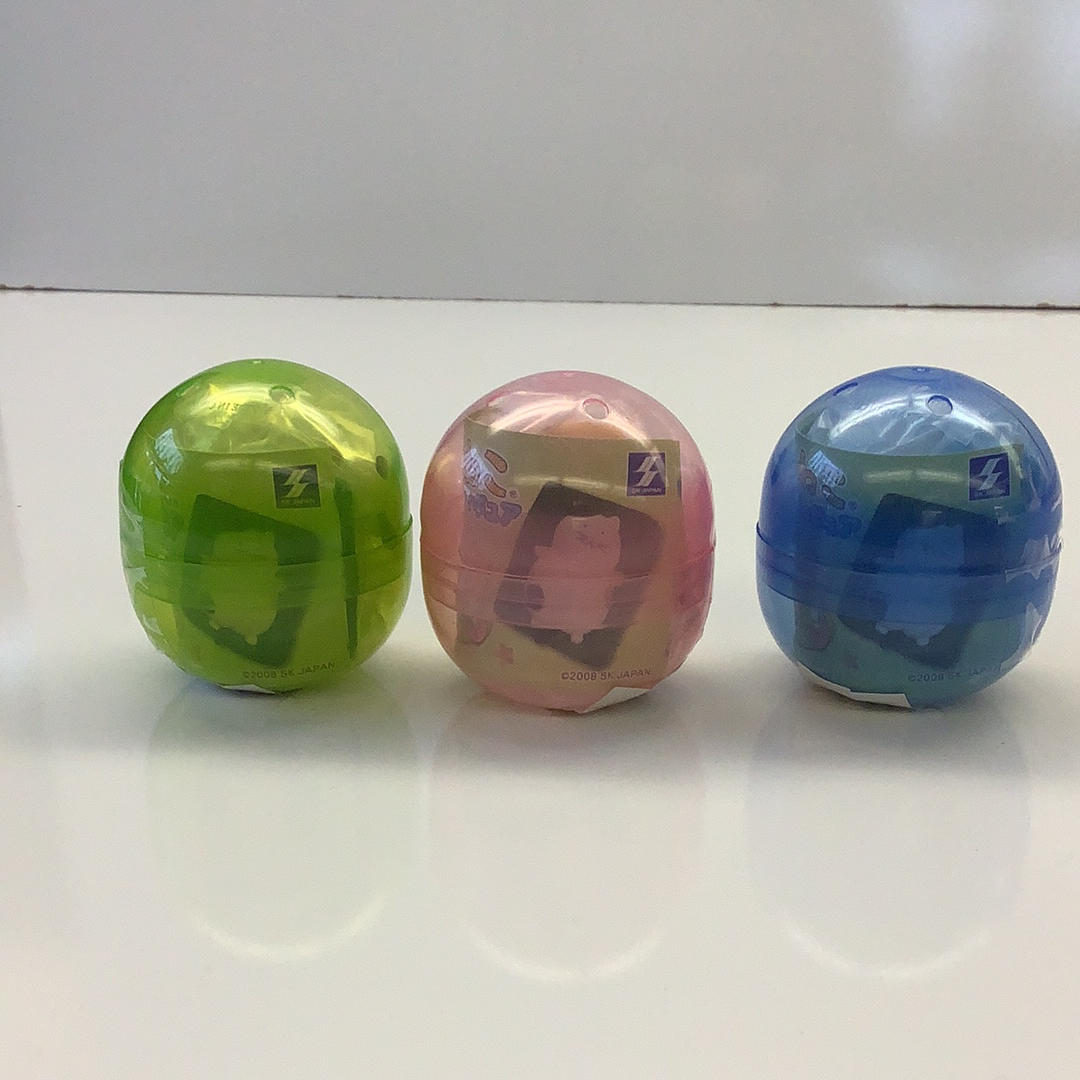 Three colorful, spherical capsules containing cat figurines for BC USA 70861