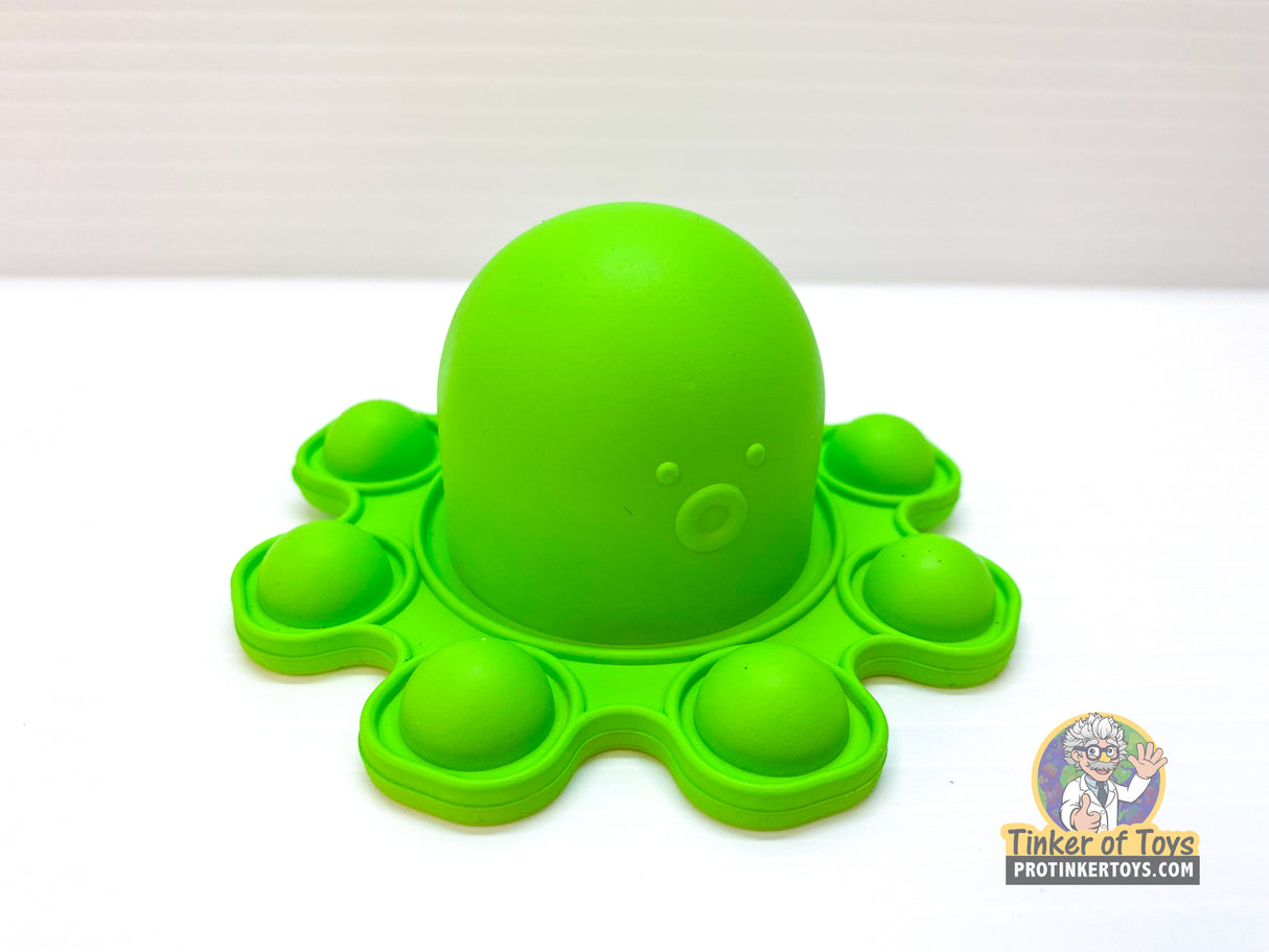 Green pop toy octopus with multiple round, pressable suction cups for BVP 88782
