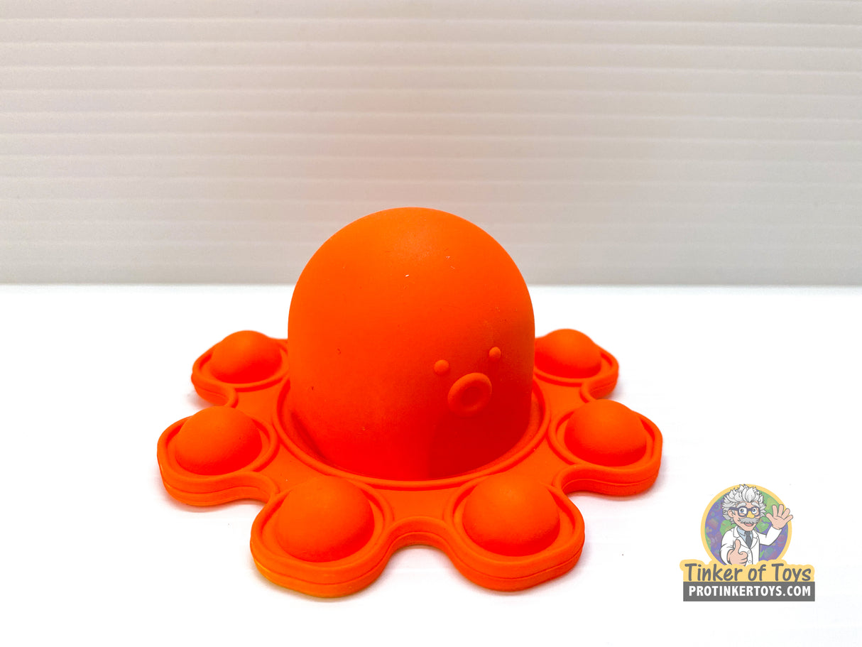 Orange pop-up octopus toy with a round head and suction cup base for BVP 88782