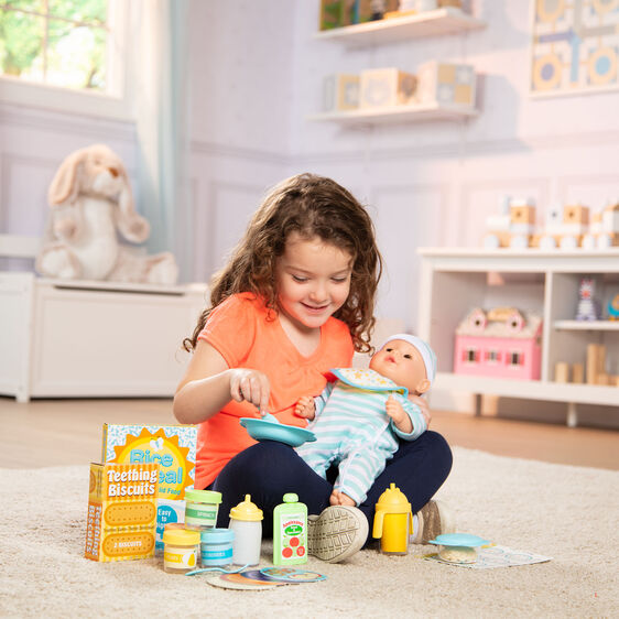 Girl plays with baby doll and pretend food set on a rug for Melissa and Doug 31708