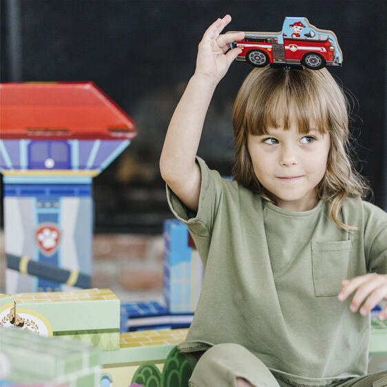 Child plays with toy vehicle near colorful building blocks for Melissa and Doug 33277