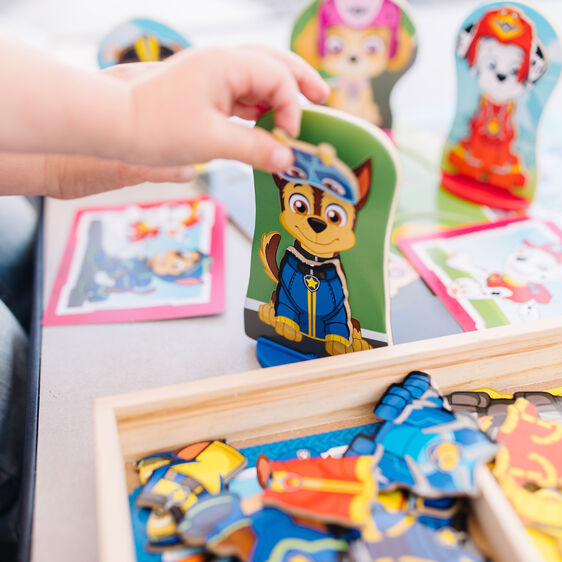 Child's hand holding a Paw Patrol magnetic cutout toy for Melissa and Doug 33267