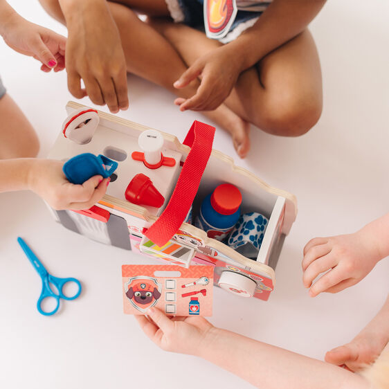 Kids playing with a wooden Paw Patrol Marshall rescue toy set for Melissa and Doug 33276