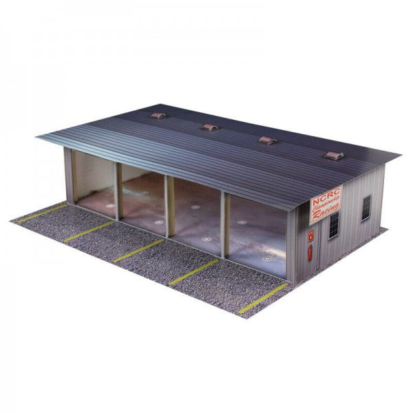 Model kit of a pit garage with a sloped roof and concrete apron for Innovative Hobby Supply BK3211