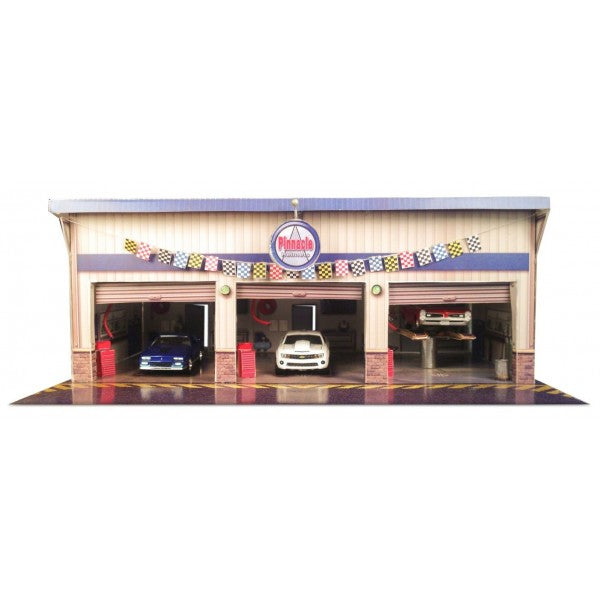 Model kit of a pit stop garage with two cars parked inside for Innovative Hobby Supply BK6423