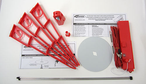 Red launch pads, controller, and launch pad components laid out for Estes EST2222