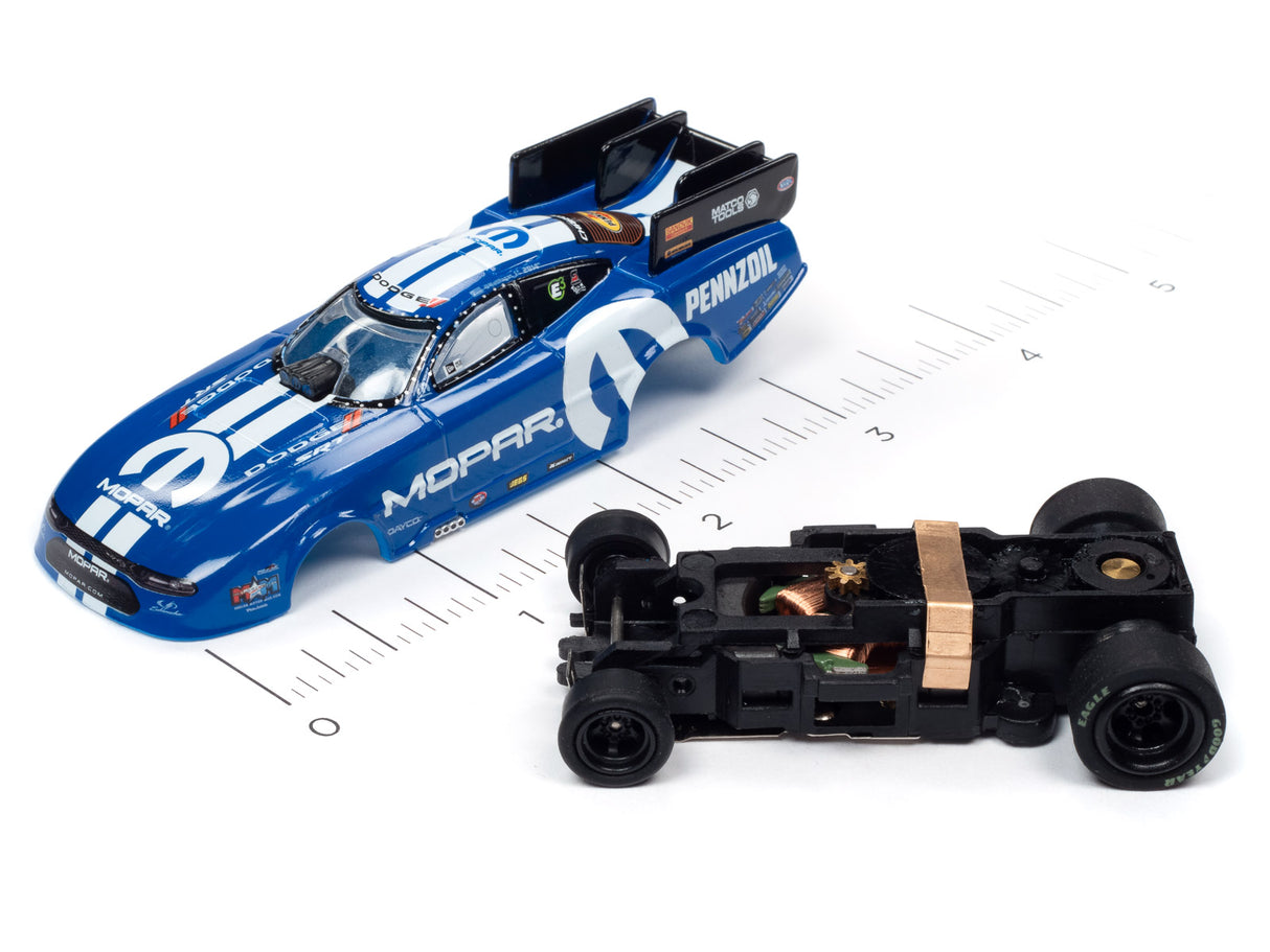 Blue drag race car model next to a black, unpainted car chassis on a ruler for Auto World SC352